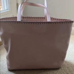 Pink leather Kate Spade bag with dark pink stitching at the top and handle